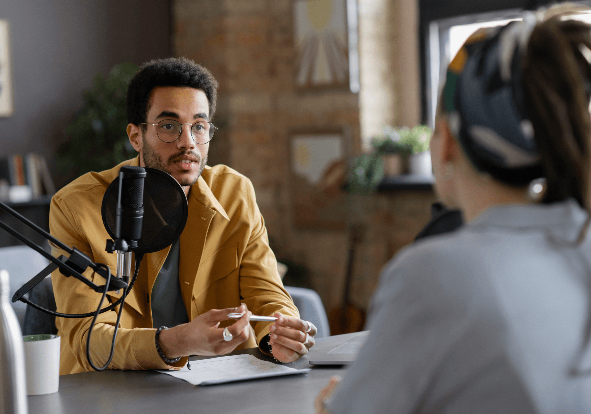 Sur l'image, nous pouvons voir un homme en train d'être interviewé par une journaliste.
